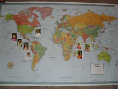 world map with children's photos attached