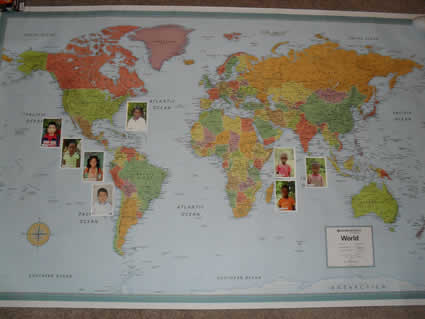 world map with photos of sponsored children