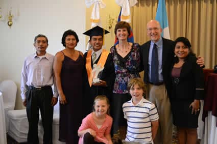 graduate posing with group of people