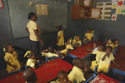 woman teaching small children in a classroom