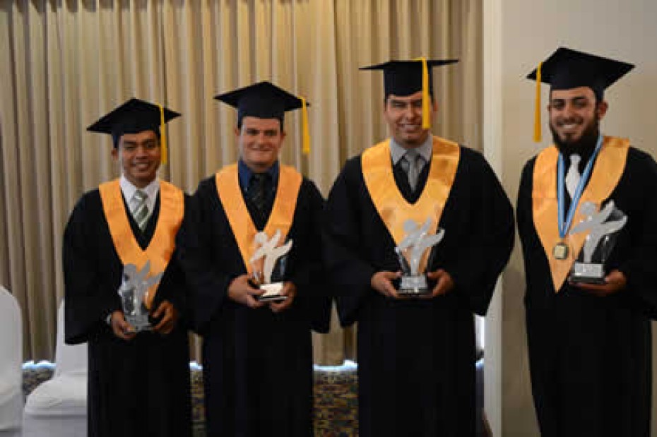 LDP-Graduation_GU four male graduates posing for camera with awards