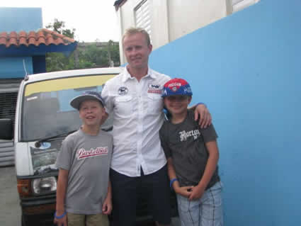 Val Bure standing between his two sons