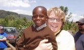 Aaron Hale holding young Tanzanian boy