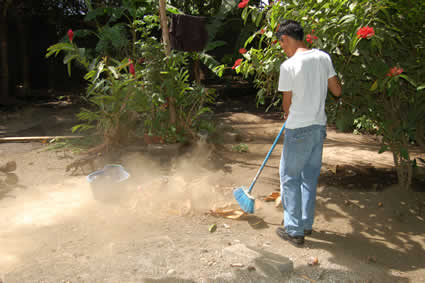 young man sweeping leaves