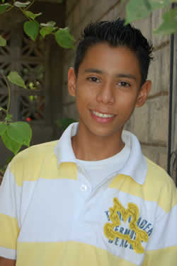 smiling boy in yellow and white striped shirt