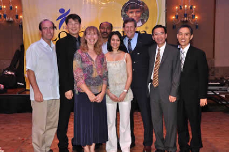 group of men and women standing and smiling