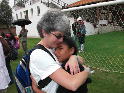 woman hugging a crying girl