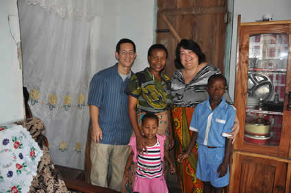 man and two women with a boy and a girl inside of a home