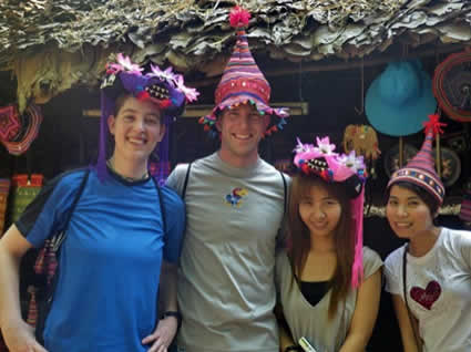 man and woman and two girls wearing colorful hats