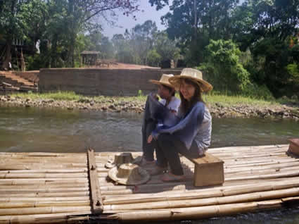 two people sitting on a raft