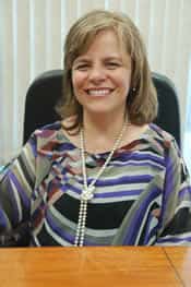 smiling woman sitting at desk