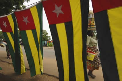 Togo flags with woman with basket on head
