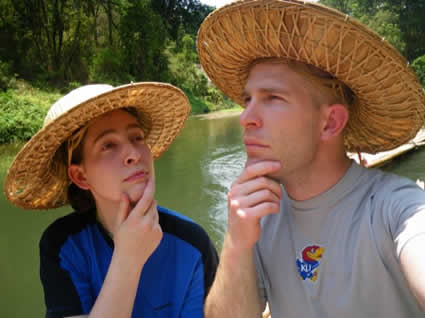 two people wearing hats with hands on chins