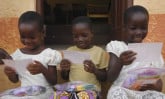 three young girls reading letters