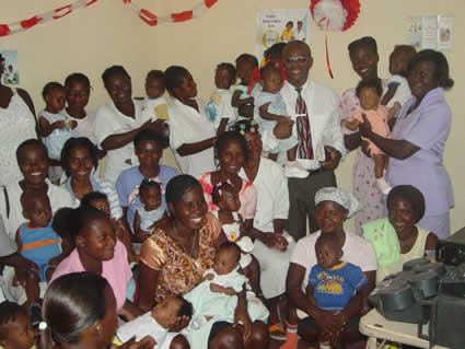 group of moms and babies with staff members