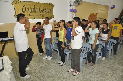 man giving instructions to a group of young people in classroom