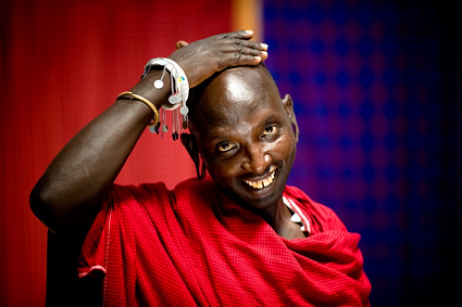 Kenyan man in traditional dress with hand on head