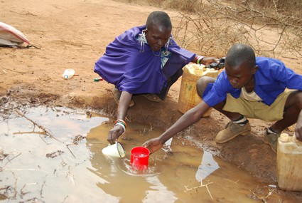 two people collecting water