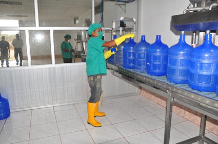 man filling empty water bottles