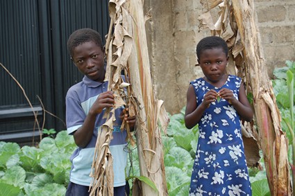 boy and girl standing outside house