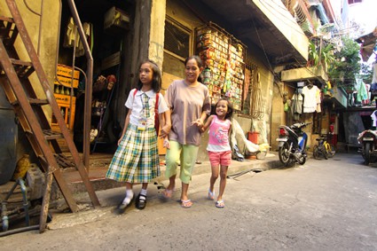 woman walking with two girls