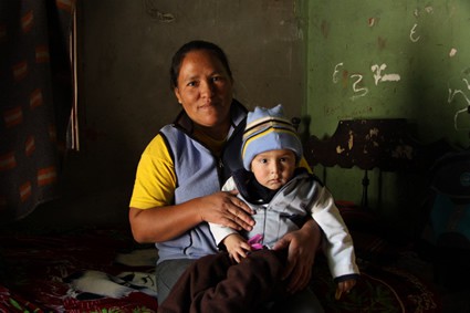 woman holding small child on her lap