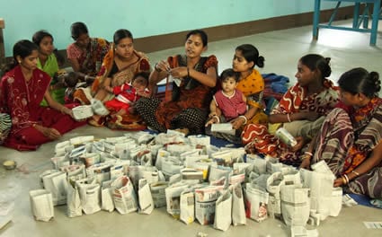women making paper bags to sell