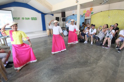 a group of people watching some girls dancing