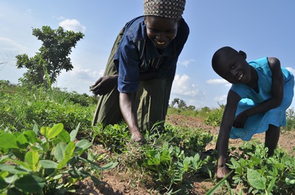 Lady and girl working in a field.