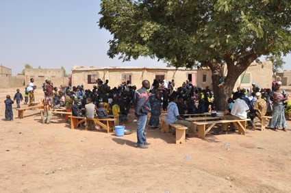 large gathering of people under a tree