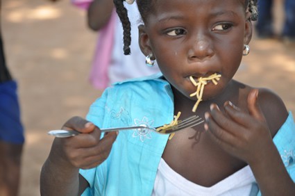 child eating food with a fork