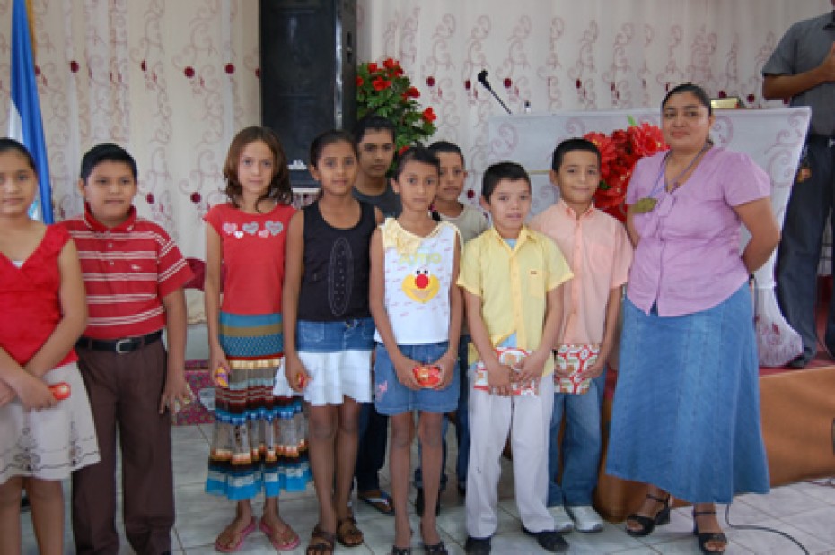 woman with group of children holding gifts