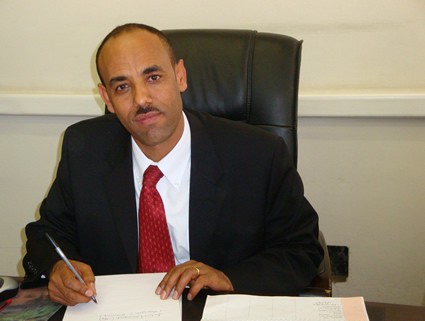 man in red tie sitting at desk
