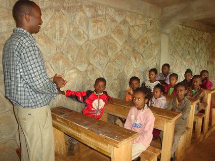 man teaching children in a classroom