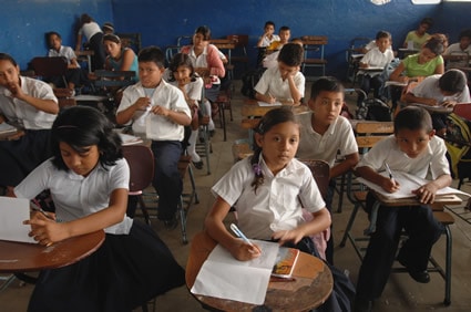students sitting at desks inside a classroom
