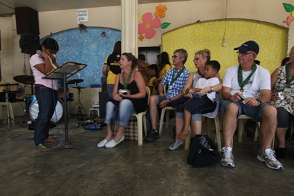 a group of people listening to someone teaching