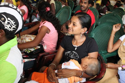 people gathered in church with woman holding a sleeping baby