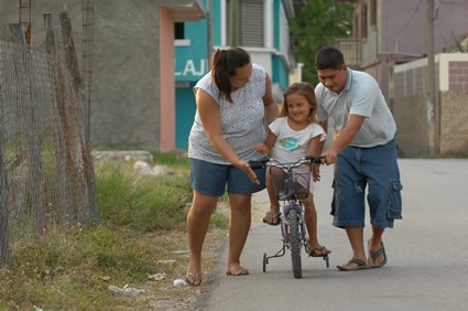 Young girl learning to ride a bicycle.