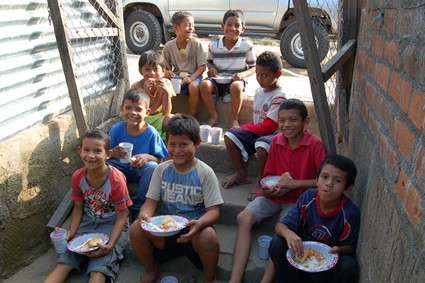 children sitting on steps eating