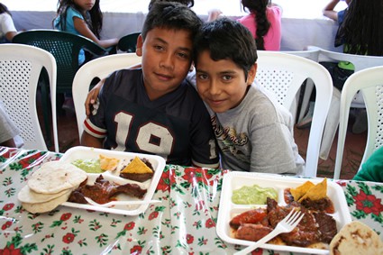 Two young boys getting ready to eat.