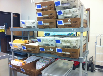 boxes of mail sitting on shelves