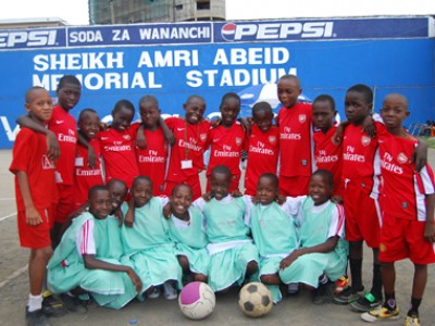a group of children with two soccer balls