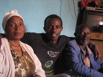 man with arms around parents