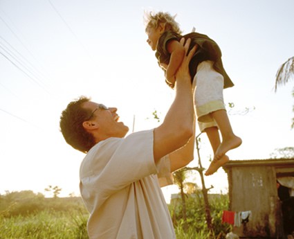 A man lifts a child in the air