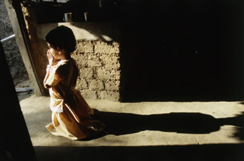 child kneeling in prayer