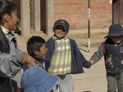 children smiling and holding hands