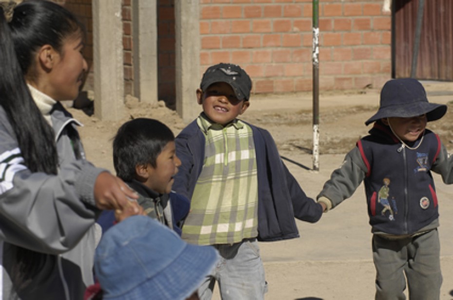 children smiling and holding hands