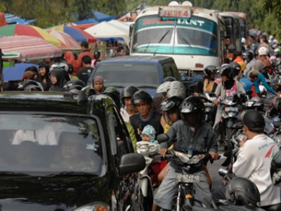 crowded street with vehicles and people