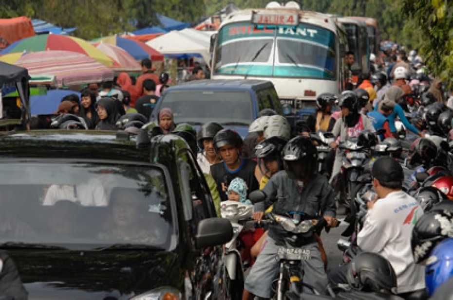 crowded street with vehicles and people