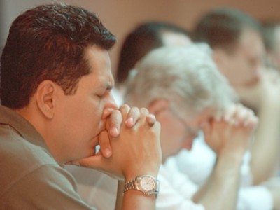 group of adults praying